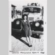 Woman in front of a car (ddr-manz-10-134)