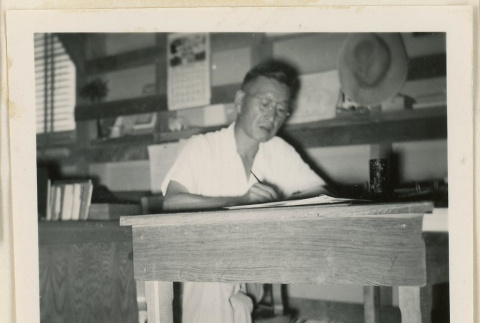 Bunji Ikanouye at a desk (ddr-densho-37-860)