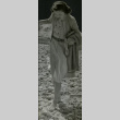 Barefoot woman walking on stones (ddr-csujad-11-175)