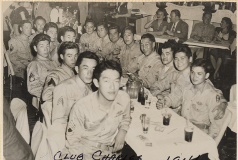 Large group of men seated around table at nightclub (ddr-densho-466-421)