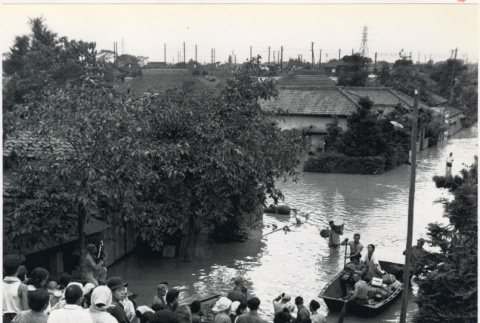 Japanese refugees row a boat through flooded streets (ddr-densho-299-112)