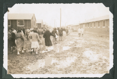 Crowd walking in a muddy camp (ddr-densho-471-14)