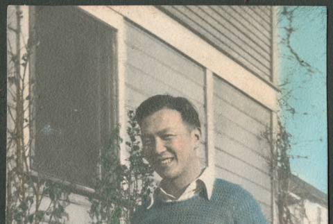 Man standing next to house (ddr-densho-523-14)
