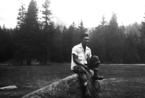 Ron Koda sitting on a rock (ddr-densho-336-4)