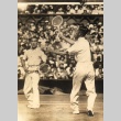 Two photos of Japanese tennis players and opponent team in a Wimbledon match (ddr-njpa-4-1536)