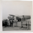 Group standing by fence at airport (ddr-densho-426-864)