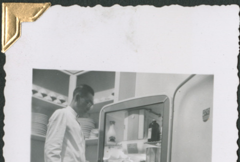 Man standing by refrigerator (ddr-densho-434-164)