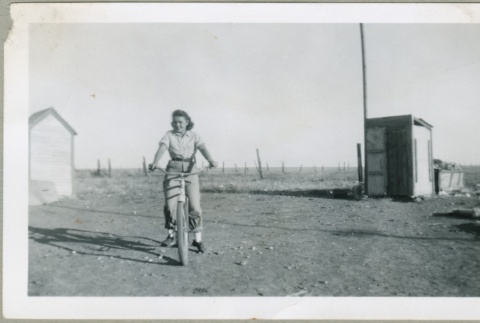 A woman on a bicycle (ddr-densho-300-139)