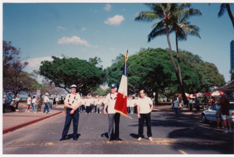 Men with flag in veterans parade (ddr-densho-368-408)