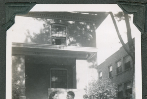 Photo of a couple in front of a house (ddr-densho-483-379)