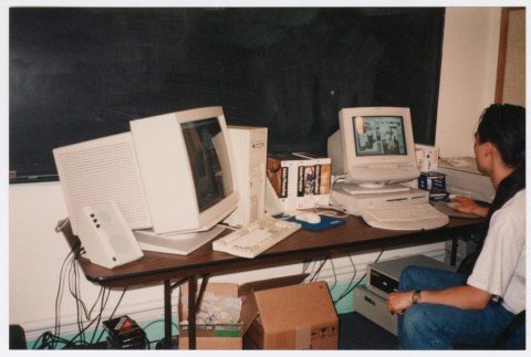 Staff member working on Densho computers (ddr-densho-506-57)