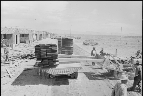 Japanese Americans unloading lumber for barrack construction (ddr-densho-37-858)