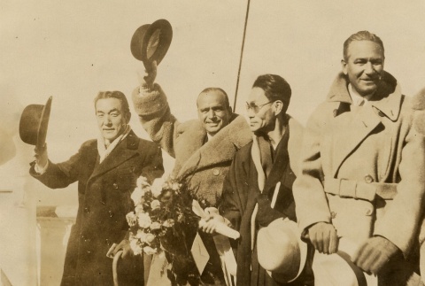 Victor Fleming, Sojin Kamiyama, Douglas Fairbanks, and Sessue Hayakawa waving on the deck of a ship (ddr-njpa-1-391)
