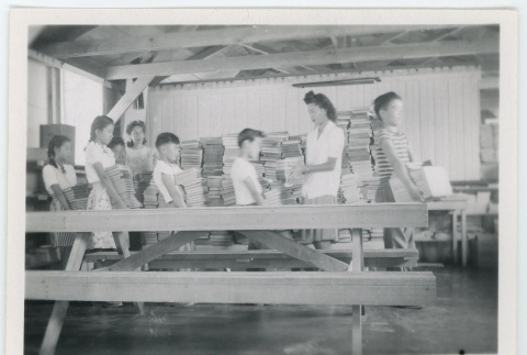 Children carrying stacks of books (ddr-densho-37-2131)