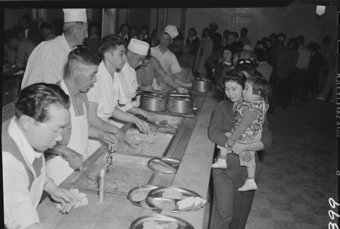 Japanese Americans serving food (ddr-densho-37-484)
