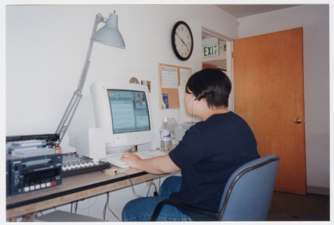 Dana Hoshide working at desk (ddr-densho-506-72)