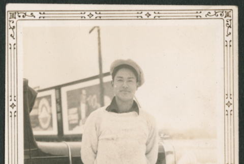Man standing in snow by car (ddr-densho-316-285)