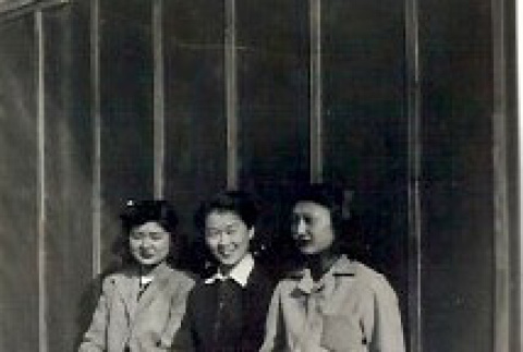 Three women sitting outside a barracks (ddr-densho-339-17)