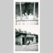 Woman and two children & family outside cabin (ddr-densho-430-208)