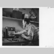 Chester Sakura working in the radio repair shop (ddr-fom-1-843)