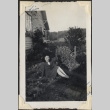 Woman sitting in garden outside house (ddr-densho-466-888)