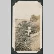 woman sitting on railing (ddr-densho-378-513)