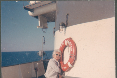 Agnes Sakura by life ring on deck of ship crossing Lake Michigan (ddr-densho-523-455)