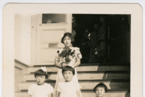 Children with flowers on steps (ddr-densho-313-67)