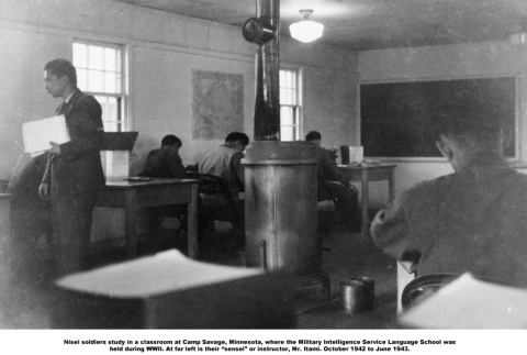 Classroom with men studying at desks and wooden burning stove (ddr-ajah-2-805)