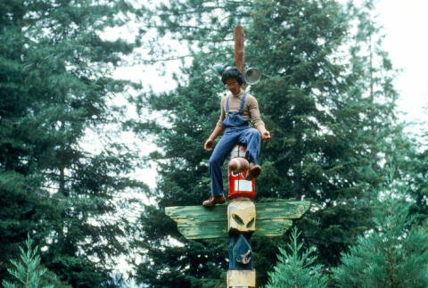Calvin Iyoya playing football from the top of a totem pole (ddr-densho-336-923)