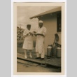 A nurse and a man in an apron sharing food (ddr-densho-223-31)