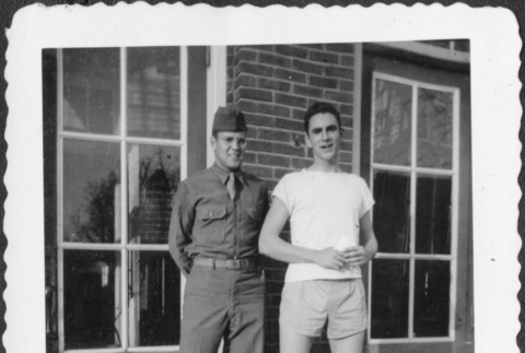 Two men standing outside building (ddr-densho-434-446)