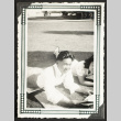 Yosh and Sadako reading on a lawn (ddr-densho-542-373)