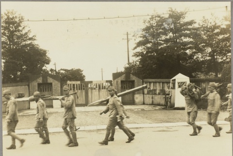 Soldiers carrying wooden stakes and tools (ddr-njpa-13-1437)