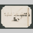 Man laying down by swimming pool (ddr-densho-545-42)