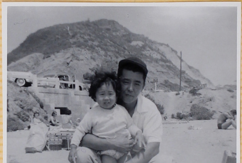 Man with small girl on beach (ddr-densho-522-296)