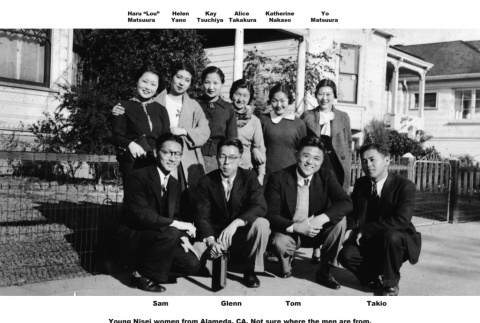 Group posing for photo on sidewalk outside house (ddr-ajah-6-114)