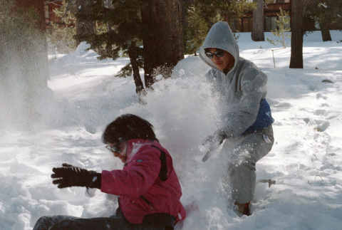 Stephanie Ide and Jon Osaki playing in the snow (ddr-densho-336-1565)