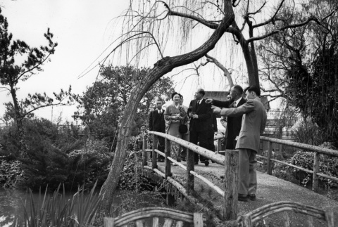 Group standing on bridge in garden (ddr-ajah-3-32)