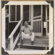 Gary Kikawa smoking on porch steps (ddr-densho-542-140)