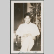 man in front of Christmas tree (ddr-densho-378-646)