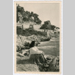 Woman sitting on rocky beach (ddr-densho-368-216)
