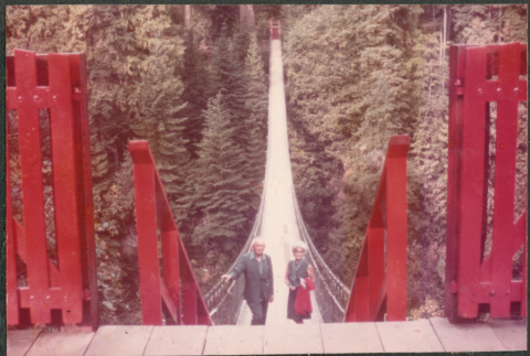 Agnes and Chester Sakura standing on suspension bridge (ddr-densho-523-571)