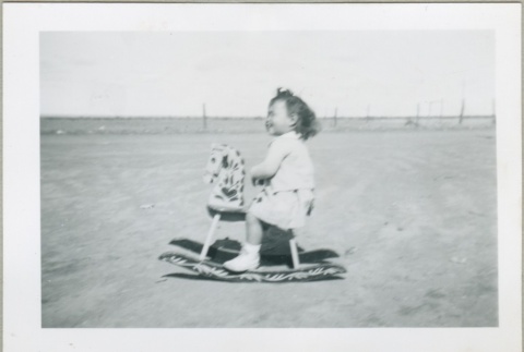 A toddler on a rocking horse (ddr-densho-300-81)