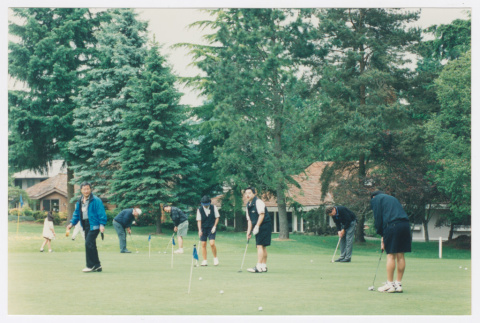 Densho Golf Tournament attendees practicing putting (ddr-densho-506-138)