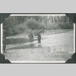 Two  men in uniform crossing a shallow creek (ddr-ajah-2-239)