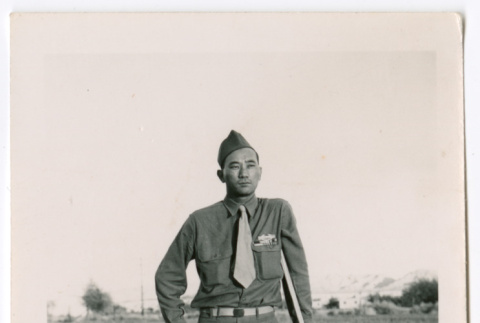 Unidentified military man standing on dirt road (ddr-densho-475-408)