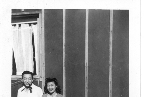 Nisei man and woman in front of barracks (ddr-densho-157-34)