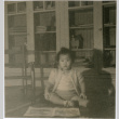 Masako Takahashi sitting on table (ddr-densho-426-976)