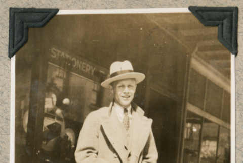 Man in hat and coat on sidewalk (ddr-densho-383-336)